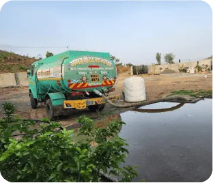 Water tanker supplying water to plantation site